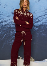 THE UPSIDE women’s maroon organic cotton Le Ski Jojo Knit Jogger features a soft knitted waistband with braided tassel drawcord, side pockets and snowflake design at ankles. Designed for Après-ski and winter wear.