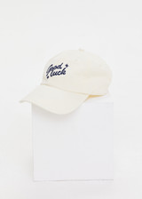 THE UPSIDE women’s cream Good Luck Soft Cap features an embroided 'Good Luck' on front with an adjustable strap at the back.