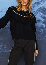 THE UPSIDE women’s navy Clara Tassle Knit Sweater is a relaxed, cable knit design featuring knotted tassels on front and back. Designed for Après-ski and winter wear.