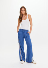 THE UPSIDE women’s blue Lykke Juliet Pant in soft chambray features a low-rise fit, split hem, and contrasting mesh knit side stripe. The perfect travel pant.