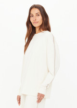 THE UPSIDE women’s creme cotton Hamsa Sunday Long Sleeve features a relaxed fit, dropped shoulders, and an embroidered evil eye on the sleeve. Perfect for layering.