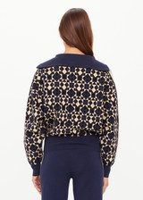THE UPSIDE women's navy organic cotton Cosmo Kairo Half Zip Knit is a relaxed fit and features a half zip front and beige knitted stripes down sleeves. Made for everyday leisure.