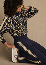 THE UPSIDE women's navy organic cotton Cosmo Kairo Half Zip Knit is a relaxed fit and features a half zip front and beige knitted stripes down sleeves. Made for everyday leisure.