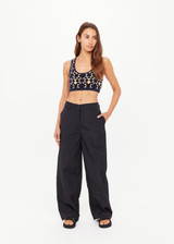 THE UPSIDE women's black recycled fabric Estelle Barrel Pant is designed for a boxy fit and features a structured waistband with belt loops and side seam pockets. Made for everyday.