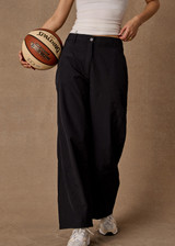 THE UPSIDE women's black recycled fabric Estelle Barrel Pant is designed for a boxy fit and features a structured waistband with belt loops and side seam pockets. Made for everyday.