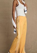 THE UPSIDE women’s lightweight yellow Juliet Pant features a low-rise fit with contrast binds and split hem detail. Perfect for travel and everyday wear.