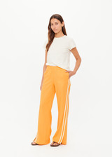 THE UPSIDE women’s lightweight yellow Juliet Pant features a low-rise fit with contrast binds and split hem detail. Perfect for travel and everyday wear.