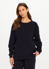 THE UPSIDE women's black recycled cotton Soho Cara Long Sleeve Top is designed for a relaxed fit and features a ribbed neck and cuffs and a patch pocket at front. Made for everyday leisure.