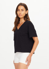 THE UPSIDE women's black Elina V Neck Tee is made from organic cotton hemp blend. This v neck boxy t-shirt features a mini patch pocket at the chest and is designed for everyday wear.