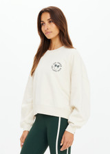 THE UPSIDE women's natural Molokai Paloma Crew is boxy fit with an embroidered green palm tree logo at front chest. Made for lifestyle.