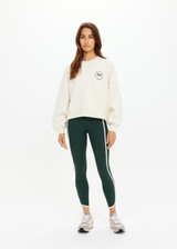 THE UPSIDE women's natural Molokai Paloma Crew is boxy fit with an embroidered green palm tree logo at front chest. Made for lifestyle.