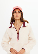 THE UPSIDE women's pink Soft Cap features a embroidered horseshoe logo on front and an adjustable strap at back with buckle. Made for lifestyle.