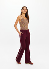THE UPSIDE women's maroon Mendoza Jackie Flare Pant is true to size and features cream piping along side seams and zipper pockets. Made for lifestyle.