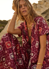 THE UPSIDE women's maroon Miri Kato silk wide-leg pant is designed for an oversized fit and features a gathered front waist with cream plaited drawcord. Made for lifestyle.