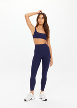 THE UPSIDE women's navy recycled peached Maison 25inch Midi Pant is mid-rise and features cream scalloped edge trim at hem. Made for yoga & pilates.