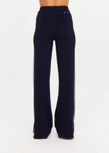 THE UPSIDE women's navy Monte Carlo Freya Knit Pant fits true-to-size and features an elasticated waistband with belt and knitted white side stripes. Made for lifestyle.