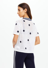 THE UPSIDE women's white organic cotton Piazza Koa Knit Shirt features a ribbed white collar with navy striped placket edge and pearlised shell button closure. Made for everyday.