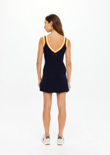 THE UPSIDE women's white organic cotton tennis Riley Knit Dress is designed for a slim fit and features wide straps and a V neckline with white stripes down the side.