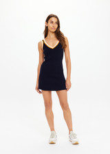 THE UPSIDE women's white organic cotton tennis Riley Knit Dress is designed for a slim fit and features wide straps and a V neckline with white stripes down the side.