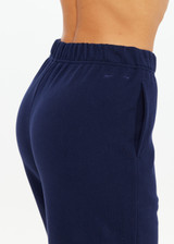 THE UPSIDE women's navy organic cotton Harrison Trackpant offers a relaxed fit and features an elasticated waistband with side pockets. Perfect for everyday comfort.