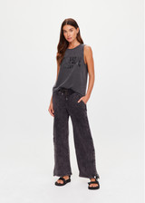 THE UPSIDE women's washed black Cosmic Wide Leg Shana Pant is a high waisted, wide-leg fit and features silver metal button snaps down leg that can be worn open.
