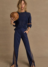 THE UPSIDE women's navy Toledo Petra Flare Pant features tan knitted tape down sides, an elasticated waistband, side pockets and splits at hem. Made for everyday wear.