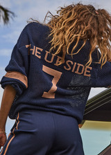 THE UPSIDE women's navy organic cotton Fenway Sebastian Crew offers a relaxed fit and features The Upside logo knit detail on back in tan. Made for lifestyle.