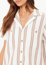 THE UPSIDE women's mocha stripe organic cotton Baja Katia Collared Shirt offers a relaxed fit and features a collar, patch pockets and wooden coconut buttons. Made for lifestyle.