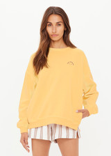 THE UPSIDE women's yellow organic cotton Paradise Coolum Crew is designed for an oversized fit, with discreet side seem pockets and ribbed neckline, cuffs and hem. Made for everyday wear.