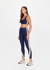 THE UPSIDE women's navy eco tech Toscan Harley Scoop Sports Bra is designed for mid coverage with a scoop front and back neckline, featuring removable cups and crafted with contrast mocha and cream binds. Made for yoga & pilates.