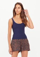 THE UPSIDE women's navy recycled soft peached Amelia Tank Top is designed with a scoop front and back neckline, and features a shelf bra with removeable cups. Made for yoga & pilates.