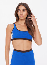 THE UPSIDE women's blue Montage Rory Scoop Knit Sports Bra is mid coverage, with a knitted scooped bra neckline, cream side pannels and a brown elasticated underbust. Made for yoga & pilates.