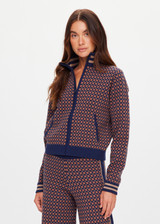 THE UPSIDE women's brown organic cotton Lumiere Margot Knit Jacket is a knitted long sleeve with a geometric star pattern, front pockets and contrast stripes around the sleeves. Made for lifestyle.