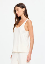 THE UPSIDE women's cream cotton Noosa Calling Tank Top is a relaxed fit in a soft brushed recycled fabrication, featuring a scoop neckline and inside bind edges. Made for lifestyle.