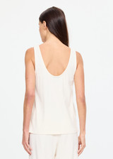 THE UPSIDE women's cream cotton Noosa Calling Tank Top is a relaxed fit in a soft brushed recycled fabrication, featuring a scoop neckline and inside bind edges. Made for lifestyle.