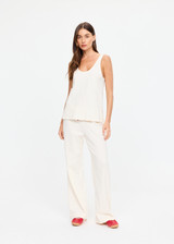 THE UPSIDE women's cream cotton Noosa Calling Track Pant is a low-rise straight leg pant with a soft elastic waistband, made from soft brushed recycled fabric. Made for lifestyle.