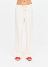 THE UPSIDE women's cream cotton Noosa Calling Track Pant is a low-rise straight leg pant with a soft elastic waistband, made from soft brushed recycled fabric. Made for lifestyle.
