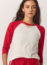 THE UPSIDE women's cream 100% organic cotton Take Me To The Ball Park Top features a soft ribbed neckline with contrast red 3/4 length sleeves. Made for lifestyle.
