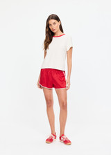 THE UPSIDE women's red 100% silk Run For Your Life Silk Short is a low-rise fit with a soft elastic waistband and cream piping along side seams. Made for lifestyle.