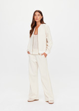 THE UPSIDE women's cream Navar Isabella Bomber Jacket is an oversized fit with raglan sleeves in our castilla "TU" design and features a front patch pocket, crafted from a knitted jacquard fabrication. Made for everyday wear.