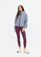 THE UPSIDE women’s grey recycled Sol Fleece Jacket has a relaxed fit with elastic waist and arm cuffs with polar fleece fabrication in marle. Made for lifestyle.