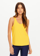 THE UPSIDE women’s yellow recycled mesh Issy Tank Top is a regular fit racerback tank and features a scoop neckline and longline silhouette. Made for performance.