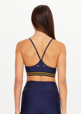 THE UPSIDE women’s navy recycled Eco Tech Salvador Zoe Sports Bra is breathable and features a scooped low neckline, T-bar back and adjustable straps. Made for yoga and pilates.