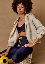 THE UPSIDE women’s grey marle organic cotton Jude Crop Hoodie offers an oversized fit and features a zip through front, hood with drawcord and ribbed cuffs and hem. Made for lifestyle.
