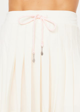 THE UPSIDE women’s cream recycled Cadiz Pleated Skirt is designed for a true to size fit and features a pleated design, built in inner short with pockets and drawcord detail. Made for tennis.