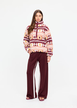 THE UPSIDE women’s recycled Harlow Fleece Pullover offers a relaxed fit and features a quarter zip front, zip pockets, elasticated waist and cuffs and all over jacquard print. Made for lifestyle.