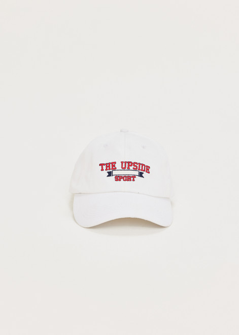 THE UPSIDE Raquette Soft Cap in White is a sustainable organic cotton soft retro fit cap with THE UPSIDE SPORT embroidered logo at front and an adjustable Velcro strap at back.
