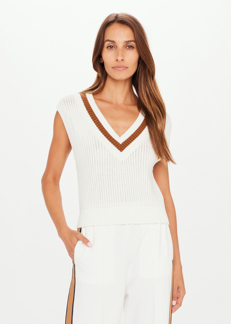 THE UPSIDE Bleeker Quinn Knit Vest in White is a sustainable organic cotton waffle knit cropped vest with a deep “V” neckline, knitted stripe neck detail and soft ribbed neckline, armholes and hem.