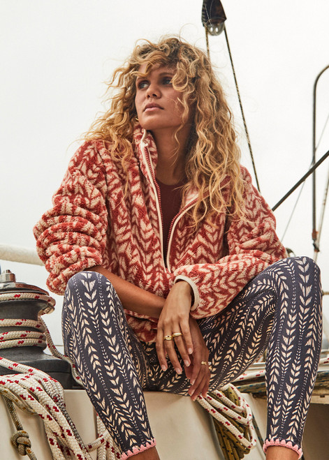 THE UPSIDE womens dark red-brown abstract pattern relaxed Niseko Harlow Pullover made with warm fleece fabrication features printed feathered arrow design, raglan sleeves, quarter zip, and elastic at waist and cuffs.