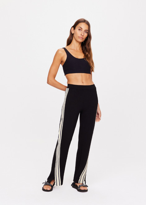 THE UPSIDE women's black Petra Flare is a flared pant with splits at front, contrast knitted tape down side seams, pockets and elastic at waist.
